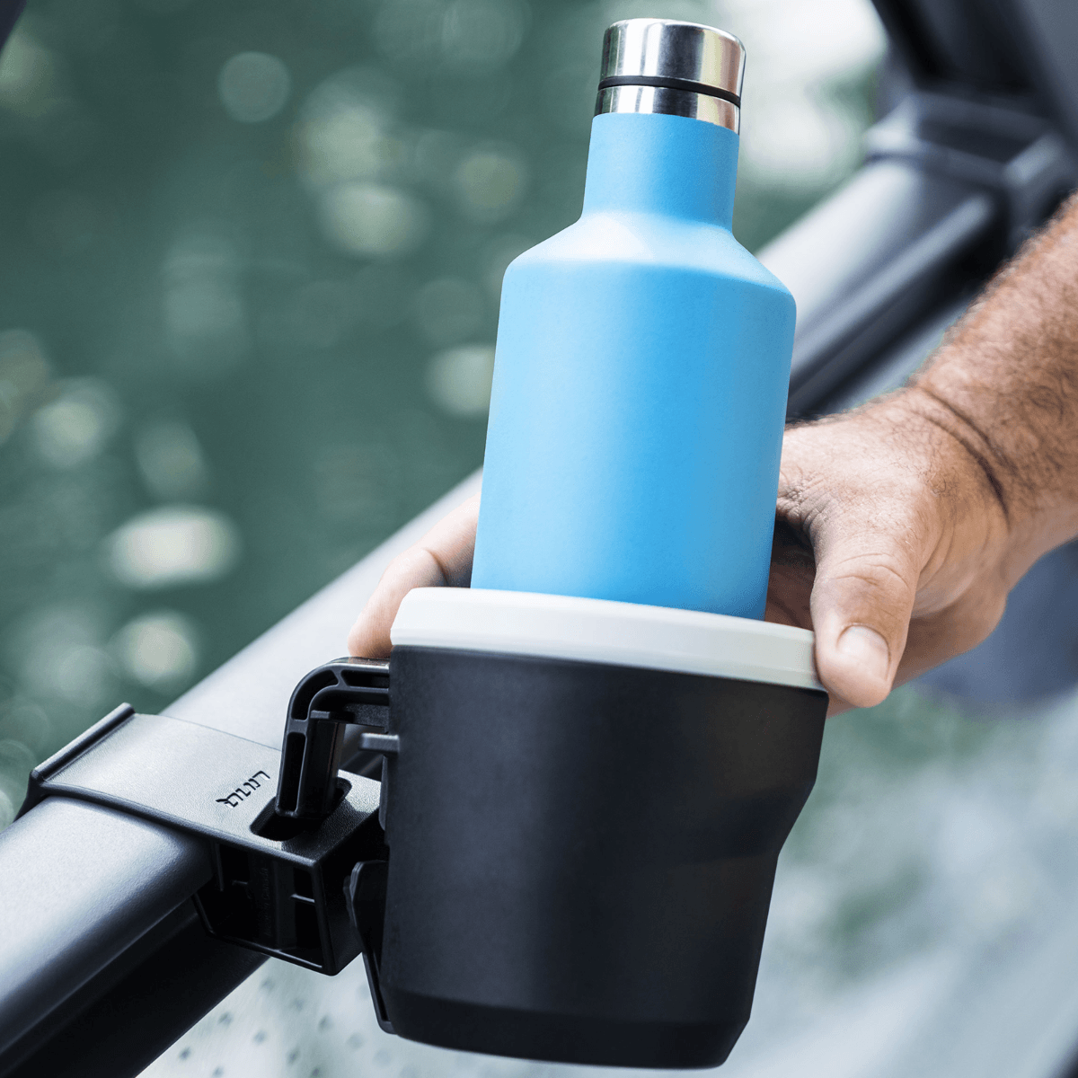 Sea-Doo LinQ Lite cup holder mounted on Switch pontoon rail holding blue bottle