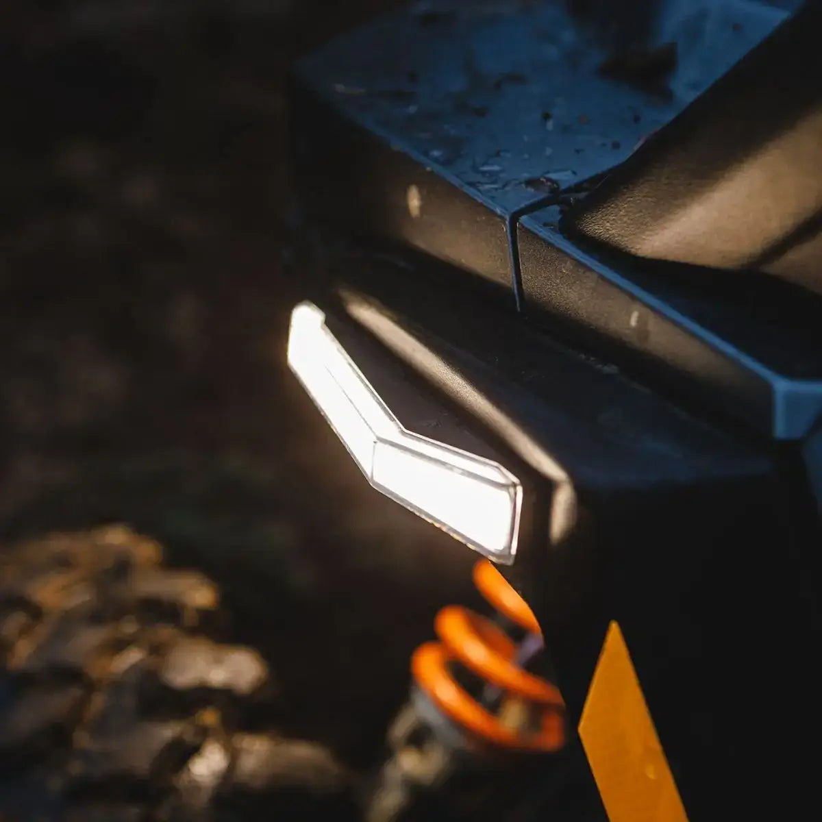 Close-up of a vehicle's headlight with a dark background