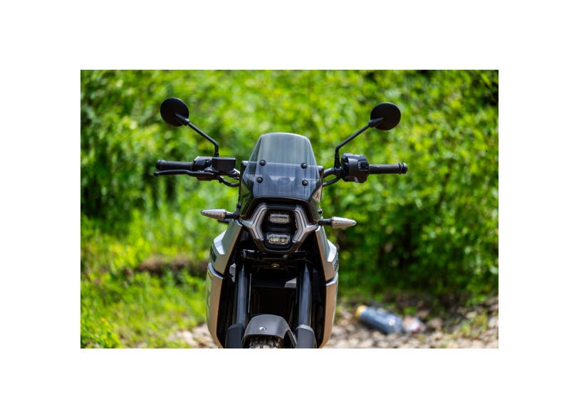 Can-Am Origin electric motorcycle front view with LinQ windshield mounted on handlebars