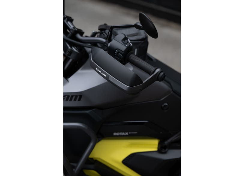 Can-Am Origin and Pulse aluminum handguards mounted on EV motorcycle handlebar close-up