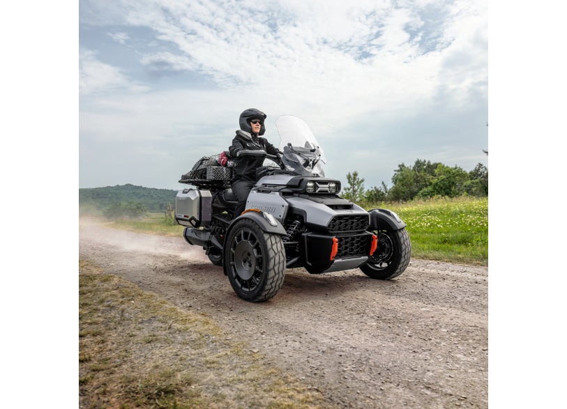 Can-Am Ryker Rally three-wheeler with Canyon skid plate riding on gravel road