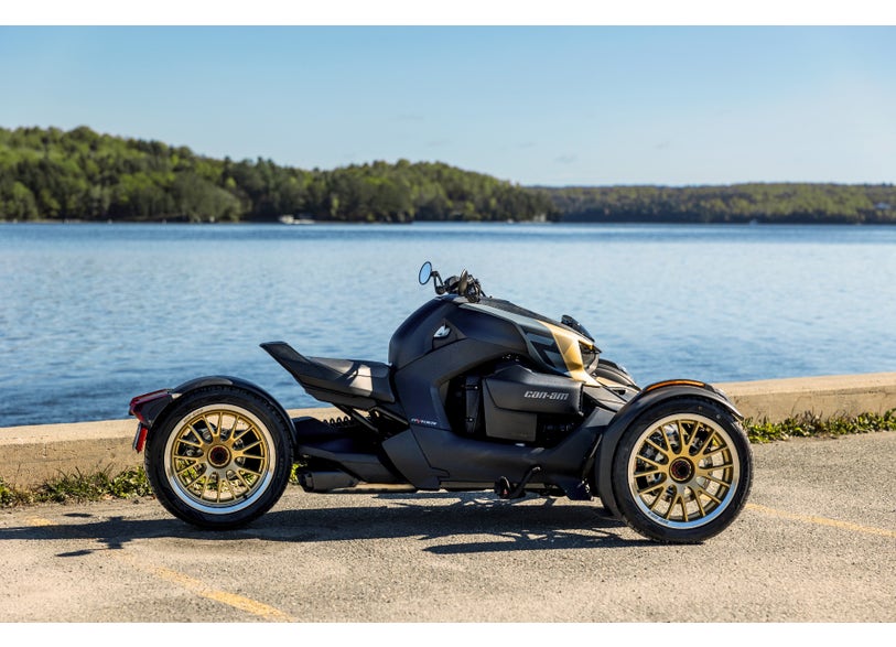 Can-Am Ryker three-wheeler with Liquid Gold Circuit rear wheel, side view parked by lakeside