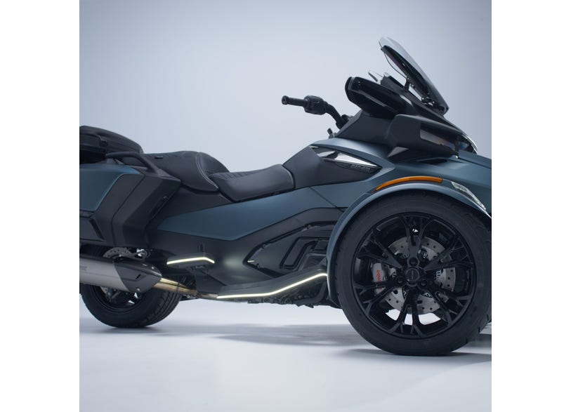Can-Am Spyder RT side profile showing driver floorboards with signature LED lights