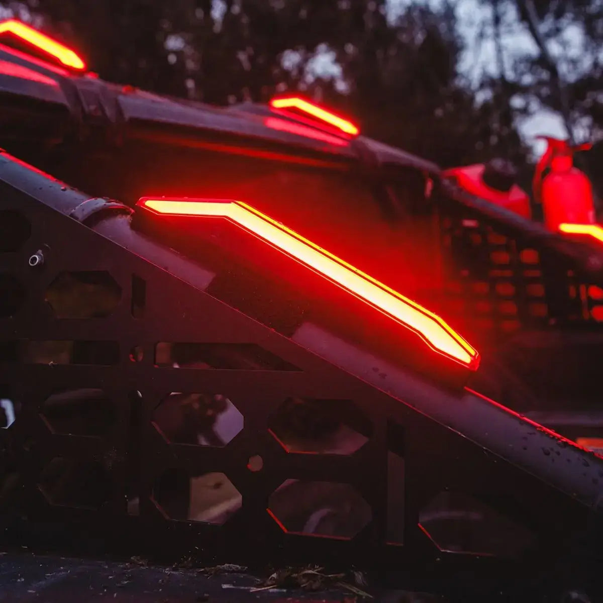 Close-up of a vehicle's red lighting system with a dark background
