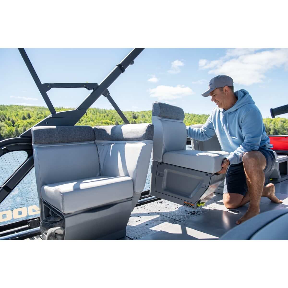 Man adjusting gray right-hand corner backrest seat on Sea-Doo Switch pontoon boat deck