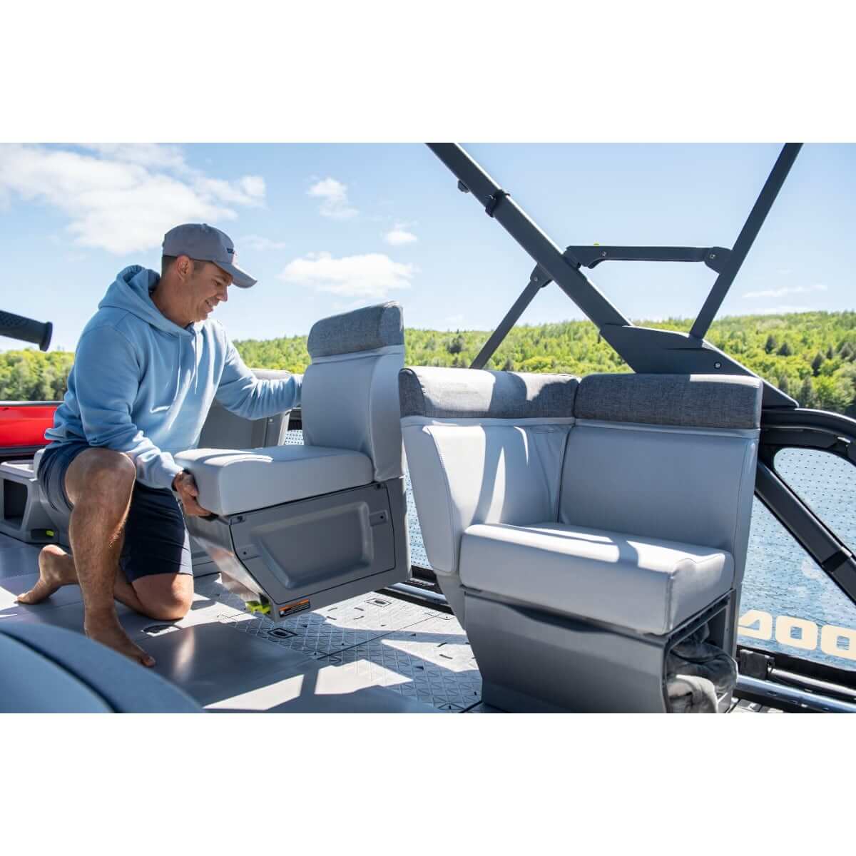 Man adjusting gray corner backrest seat on Sea-Doo Switch pontoon boat, left hand support