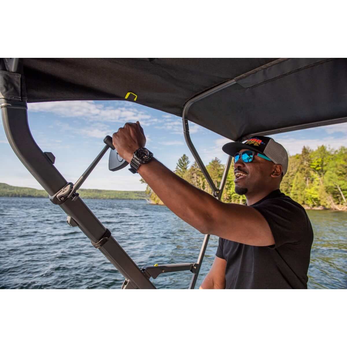 Sea-Doo Switch pontoon rearview mirror mounted on bimini top frame with rider adjusting on water