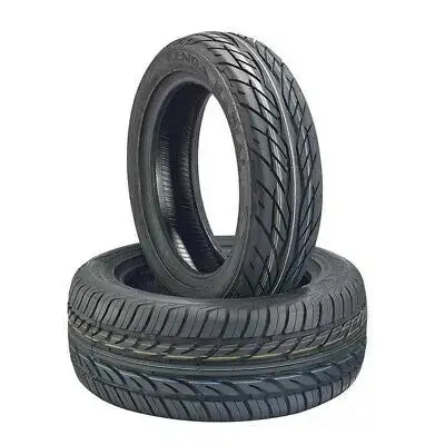 Two tires stacked on a white background