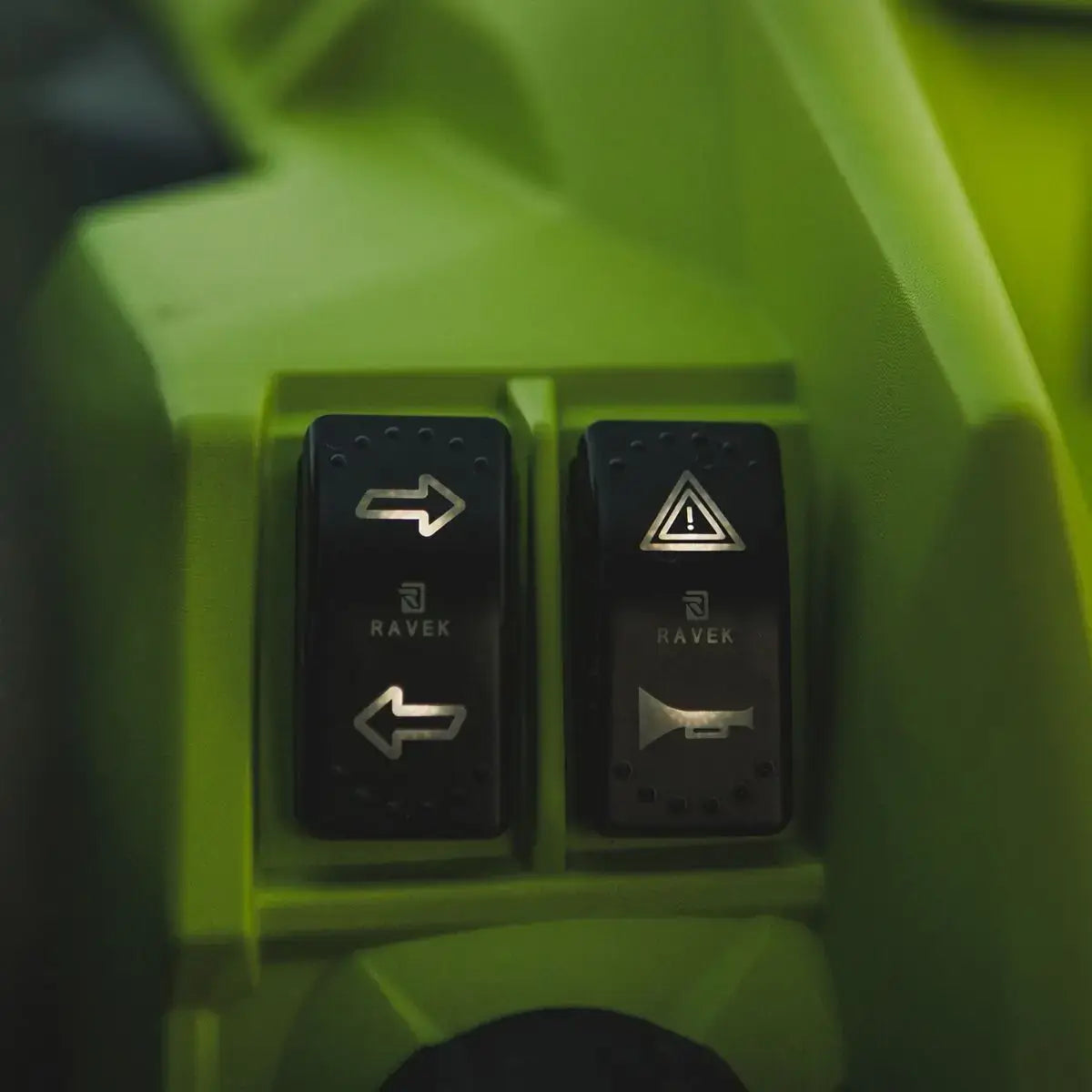 Control buttons on a green machine with symbols and text