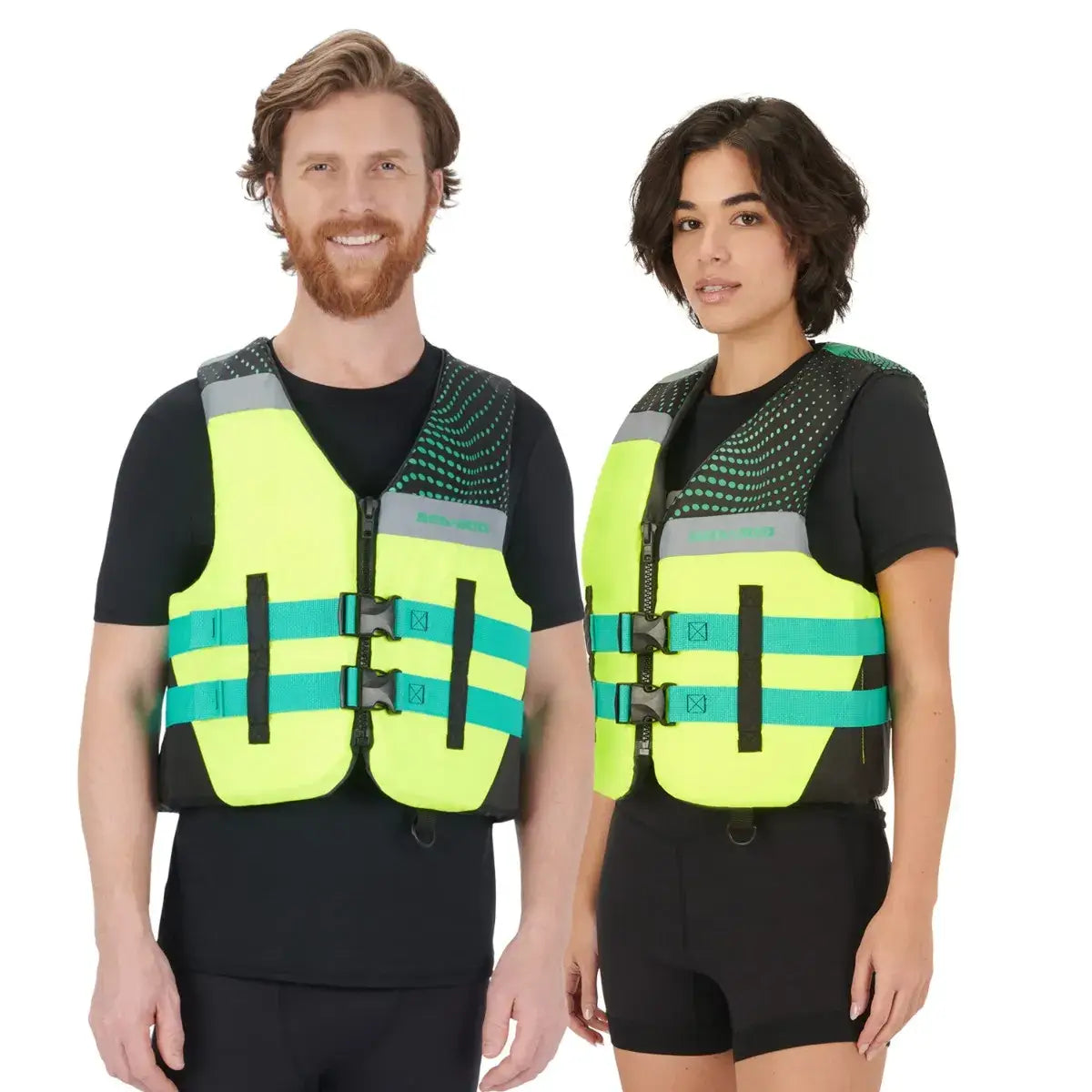 Sea-Doo unisex Motion PFD life jacket with bright yellow and green design, worn by male and female models, ideal for water sports.