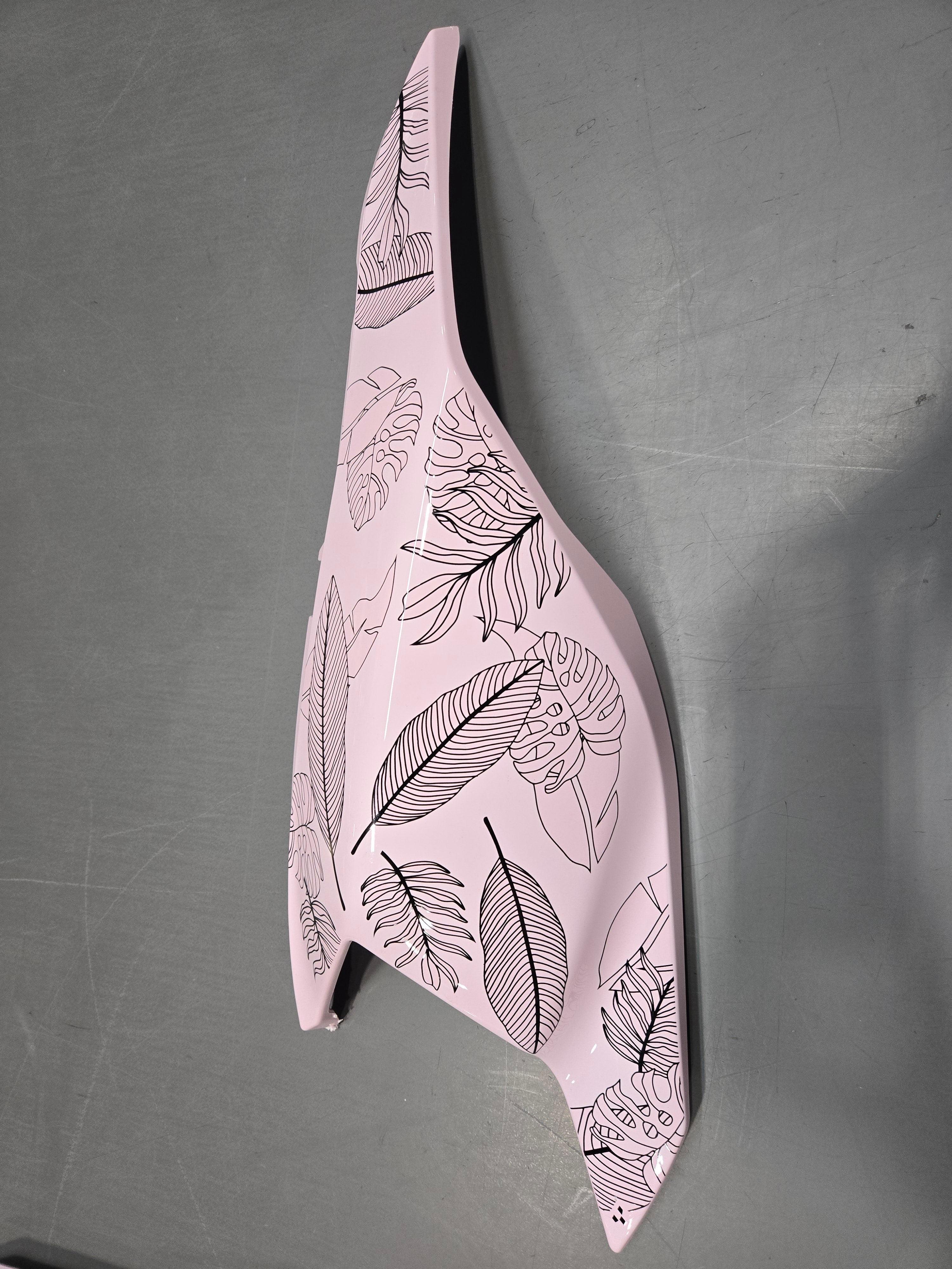 Decorative object with leaf patterns on a gray background