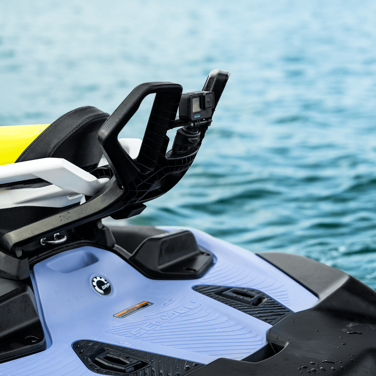 Action camera mounted on Sea-Doo Spark Spotter handle grab bar, blue and yellow PWC on water