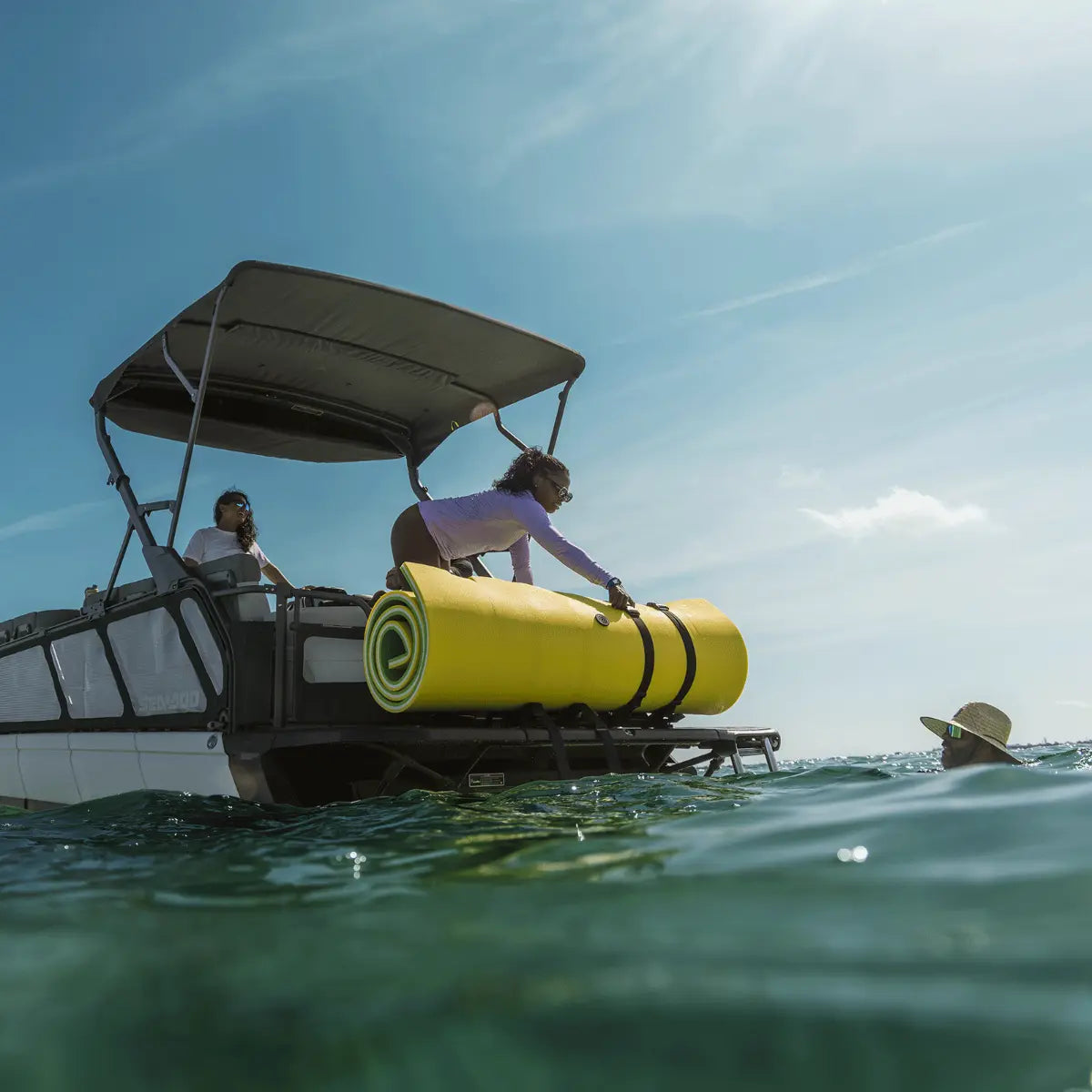 Sea-Doo LinQ rear floating mat holder mounted on Switch pontoon boat with rolled yellow water mat