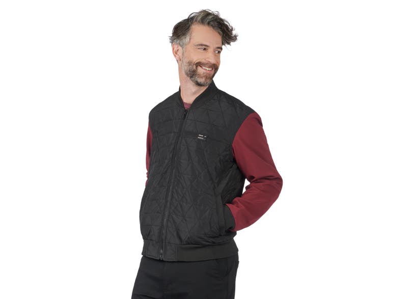 Man wearing Can-Am Cuna Bomber Jacket black quilted vest with maroon sleeves