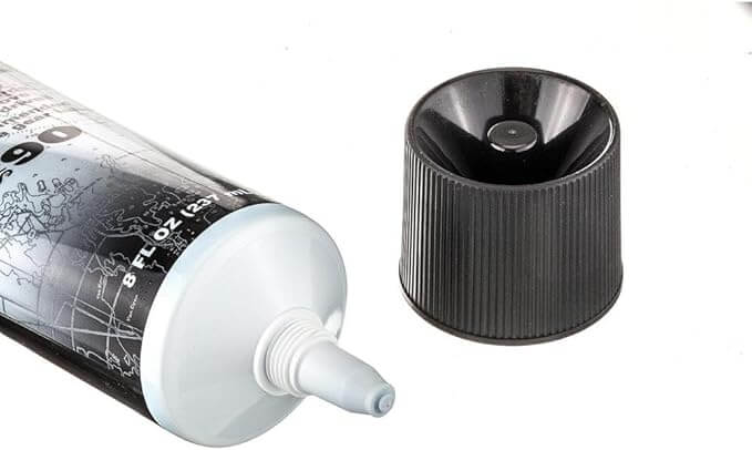 Tube of Quicksilver Gear Lube with cap off on white background