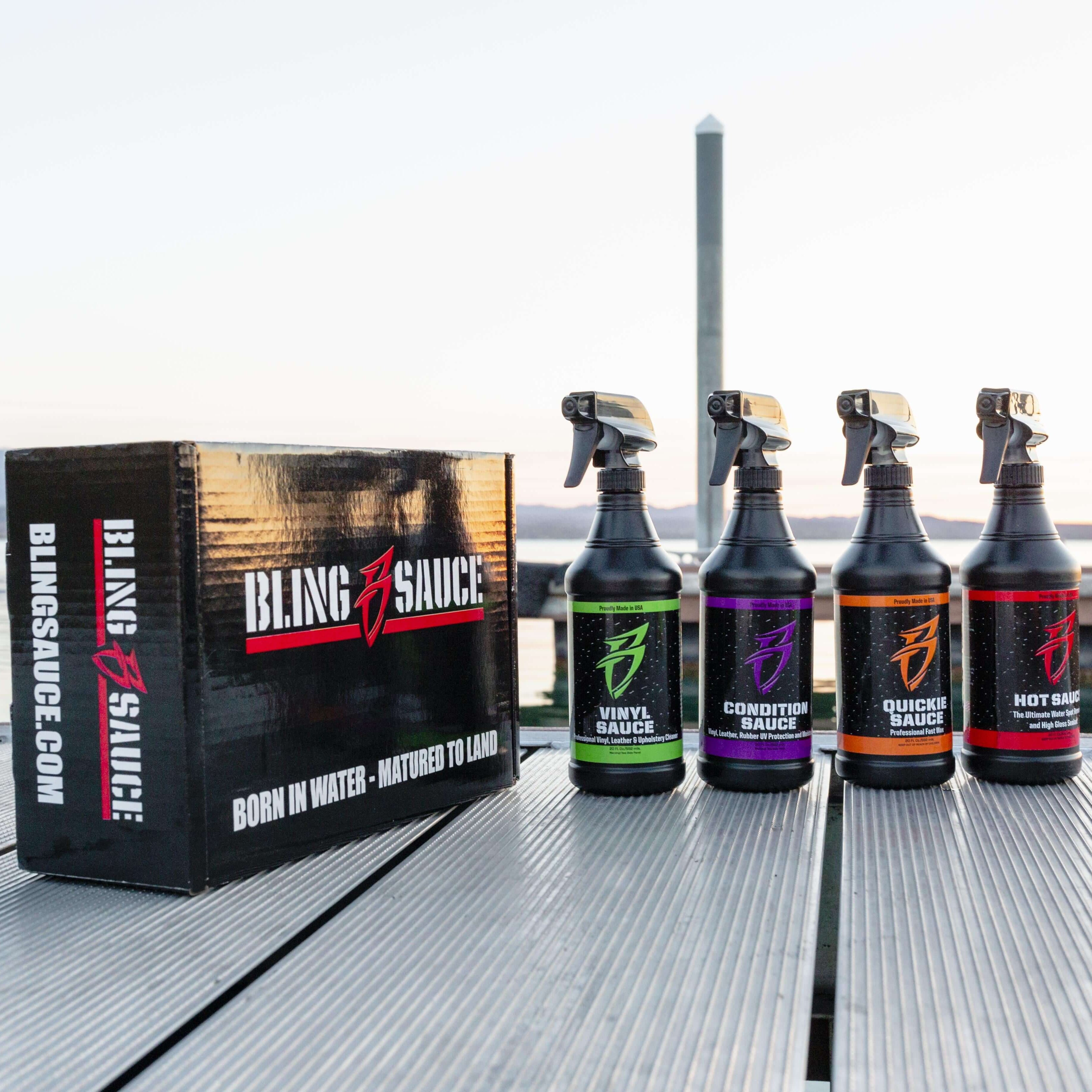 Bling Sauce product packaging and bottles on a dock with water and sky in the background