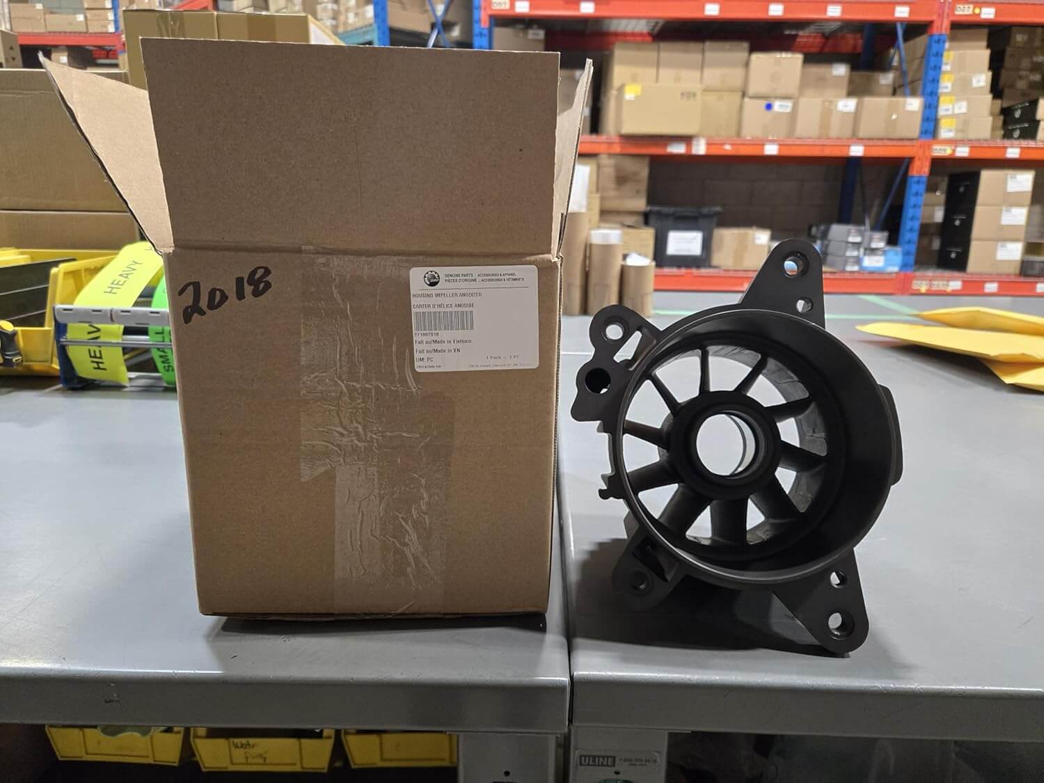 Anodized PWC jet pump housing impeller for Sea-Doo 4-Tec, 2017 and up, next to packaging box.