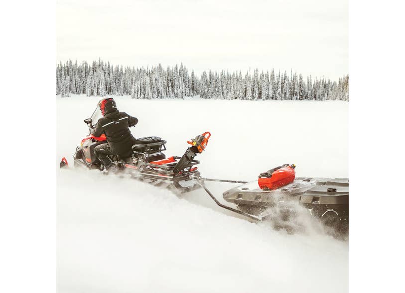 Ski-Doo Skandic snowmobile towing black LinQ cargo sled via rear rack attachment in snow, 860201800