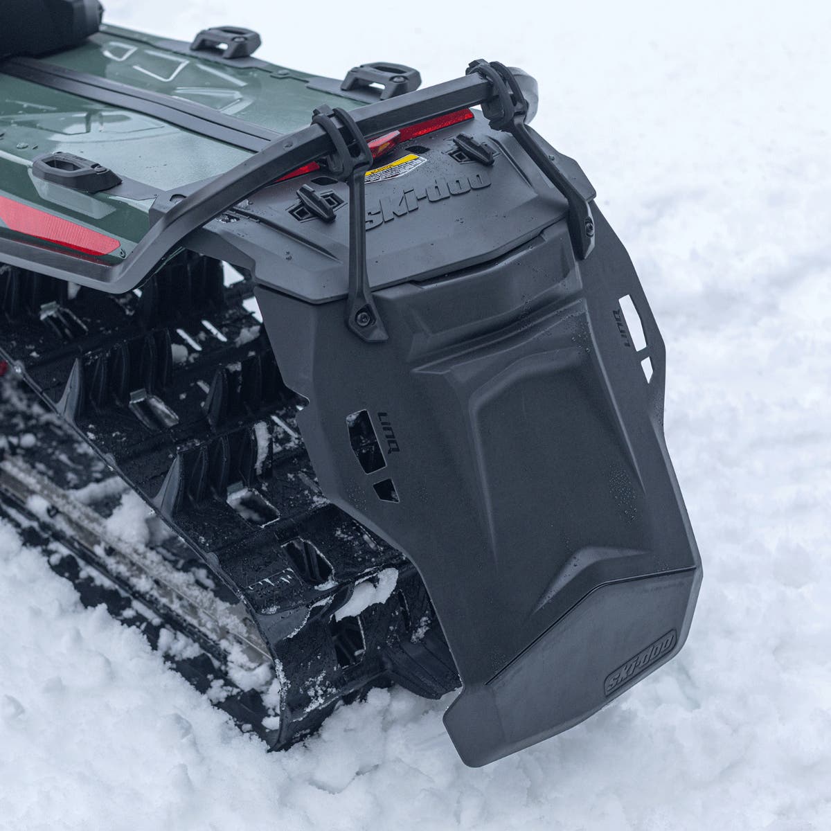 Ski-Doo LinQ lightweight snowflap extension mounted on rear tunnel of green REV Gen5 snowmobile, 860202393