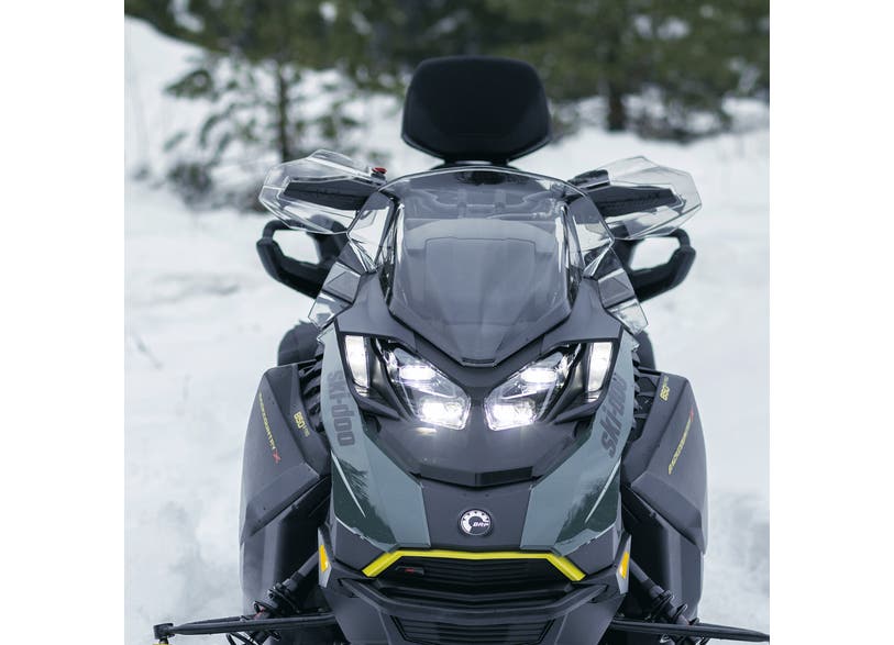 Ski-Doo REV Gen5 snowmobile front view showing auxiliary LED wide light headlights in snow