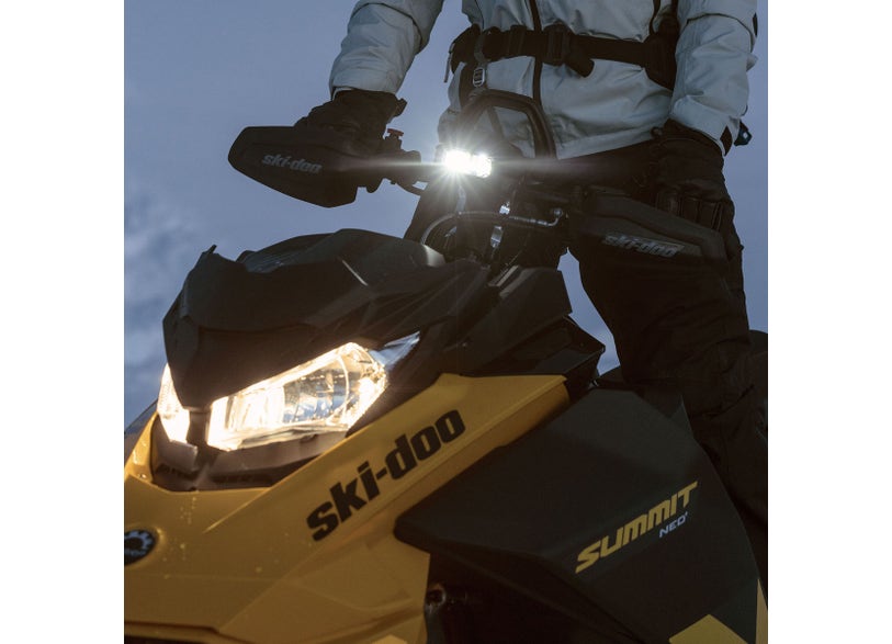Ski-Doo Auxiliary LED Light 860202429 mounted on Summit snowmobile handlebar illuminated at dusk