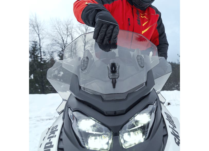 Rider installing the Ski-Doo Windshield Side Deflector Kit 860202437
