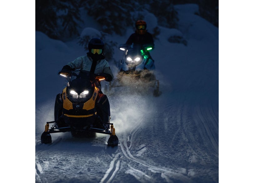 Ski-Doo REV Gen5 snowmobile with LED signal lights riding on snow trail at night, headlights illuminated, 860202619