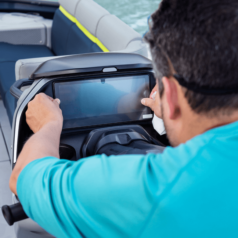 Person operating a boat with a touchscreen display