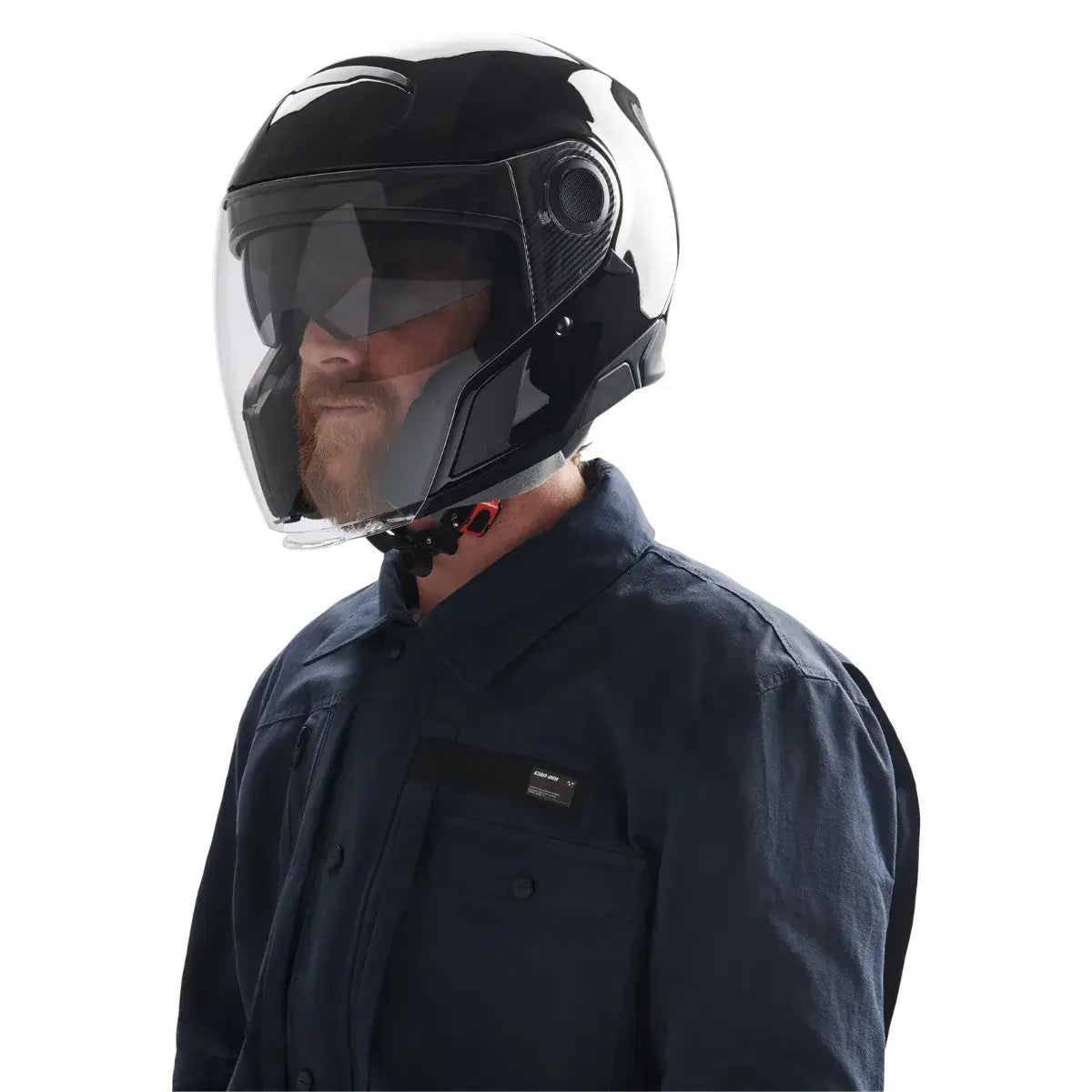 Person wearing a black motorcycle helmet with a clear visor on a white background