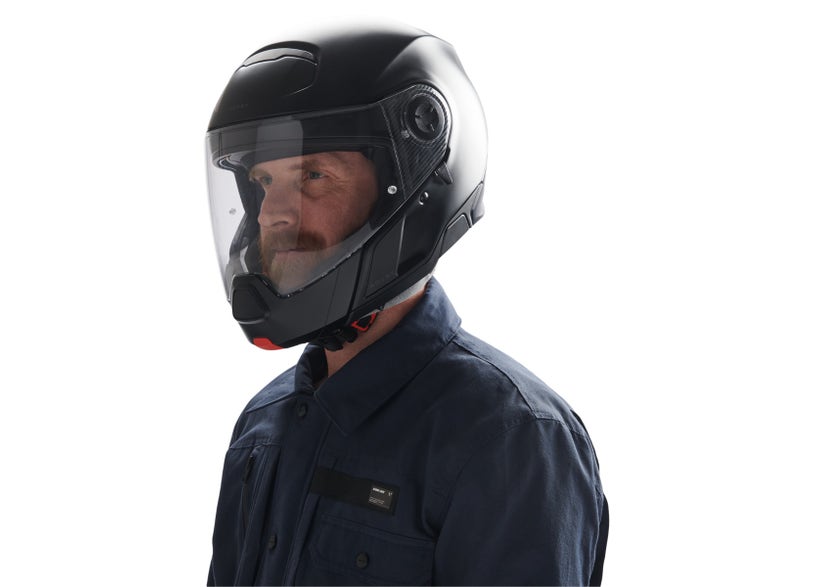 Can-Am Advex modular motorcycle helmet in black worn by rider side view clear visor down DOT ECE