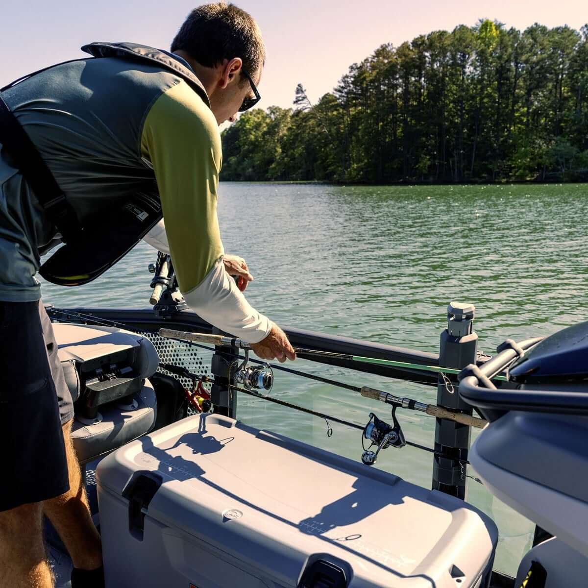 Angler accessing fishing rods from Sea-Doo Quick-Access Rod Storage on Switch pontoon boat