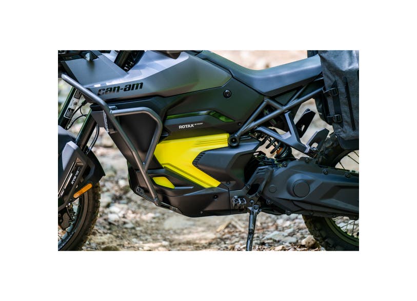 Can-Am Origin adventure motorcycle side guards installed on EV Rotax engine, close-up view