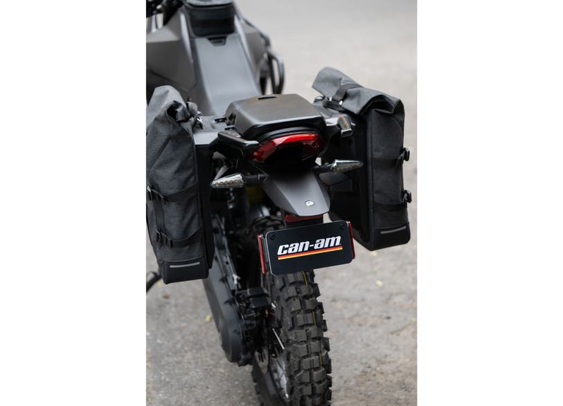 Can-Am Origin LinQ soft saddlebags 22L mounted on rear of Can-Am electric motorcycle