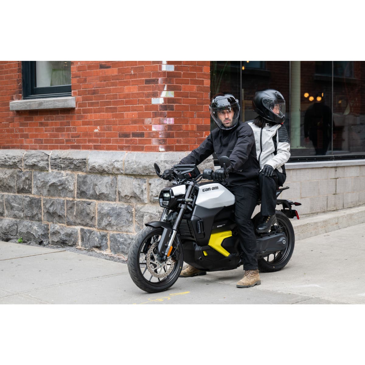 Can-Am Pulse electric motorcycle with passenger seat and footpegs installed rider and passenger city street