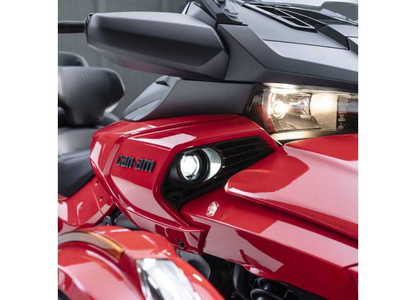 Can-Am Spyder F3 red front fairing with auxiliary lights and headlight close-up