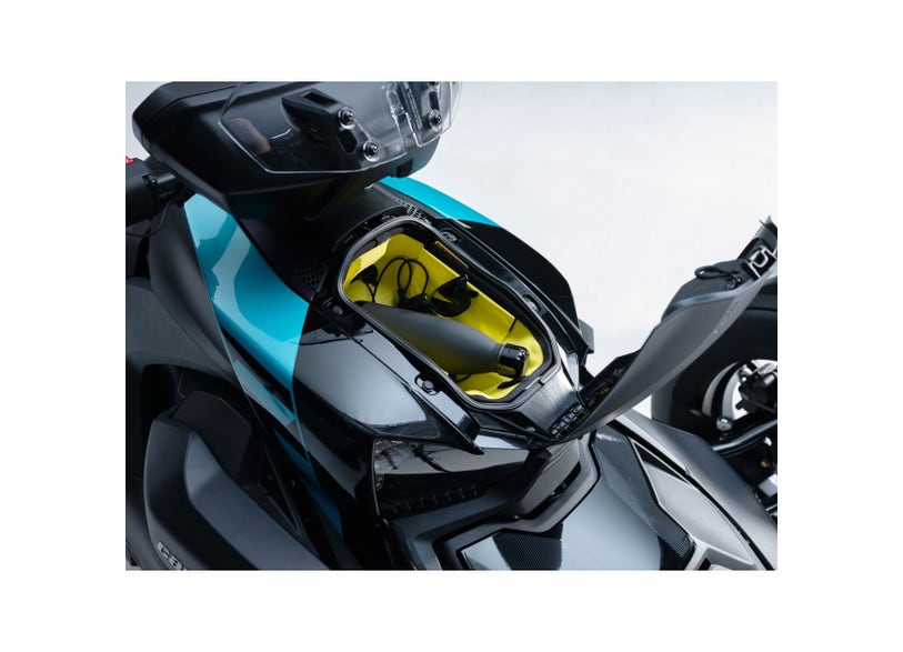 Can-Am Ryker front storage organizer installed in open frunk compartment with charging cable
