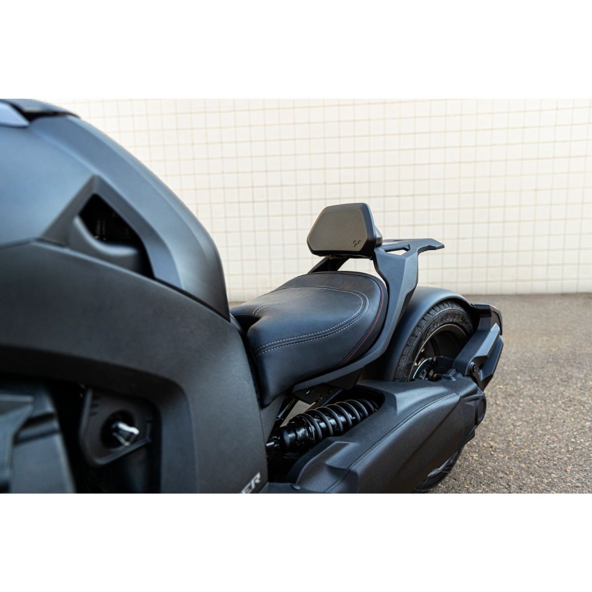 Can-Am Ryker driver backrest mounted behind black leather seat, rear angle view