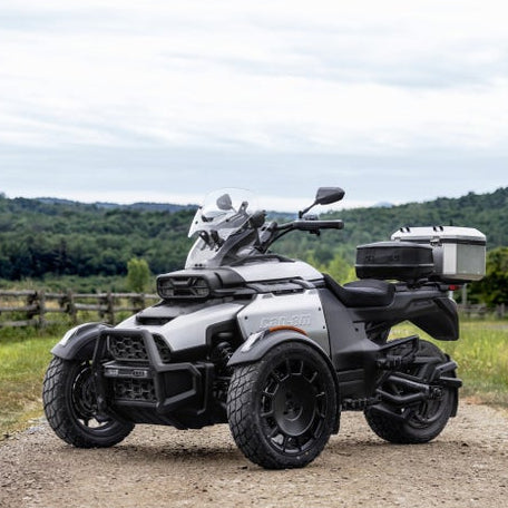 Can-Am Spyder Canyon Sport three-wheeler with tinted windshield and rear cargo case, outdoor countryside view
