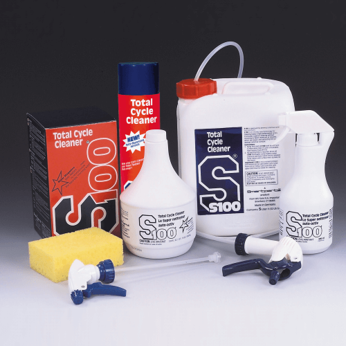 Collection of Total Cycle Cleaner products including bottles, a box, and cleaning tools on a gray background.