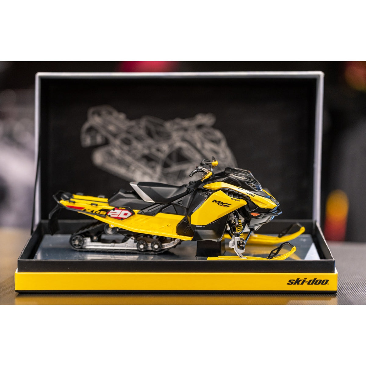 Ski-Doo MXZ XRS 20th Anniversary 1:12 diecast replica side view in open Ski-Doo display box