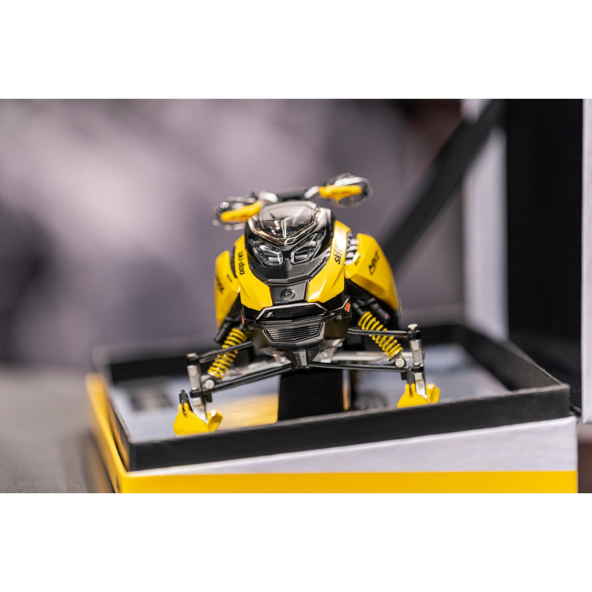 Front three-quarter view of the 1:12 Ski-Doo MXZ XRS diecast replica on mirrored display base